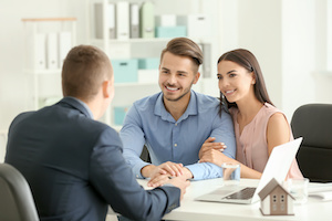 Real estate agent working with clients in office